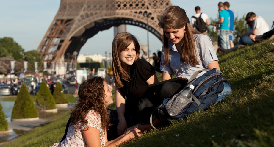 Three young women on lawn in front of Eiffel Tower, © Alan Bailey